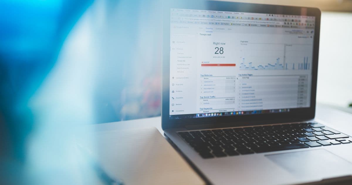 A laptop showing a live web analytics dashboard