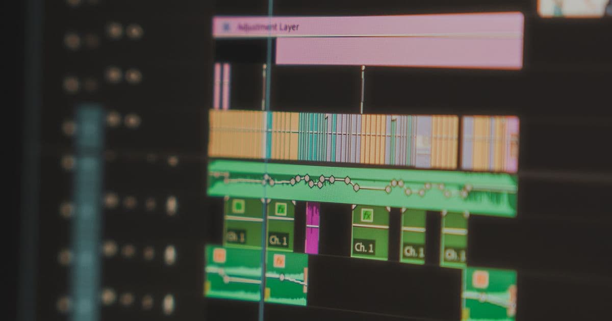 A video editing timeline with colour-coded clips on a computer screen